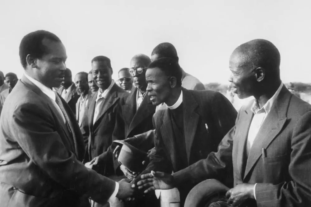 Old photo of Gabarone founders shaking hands.